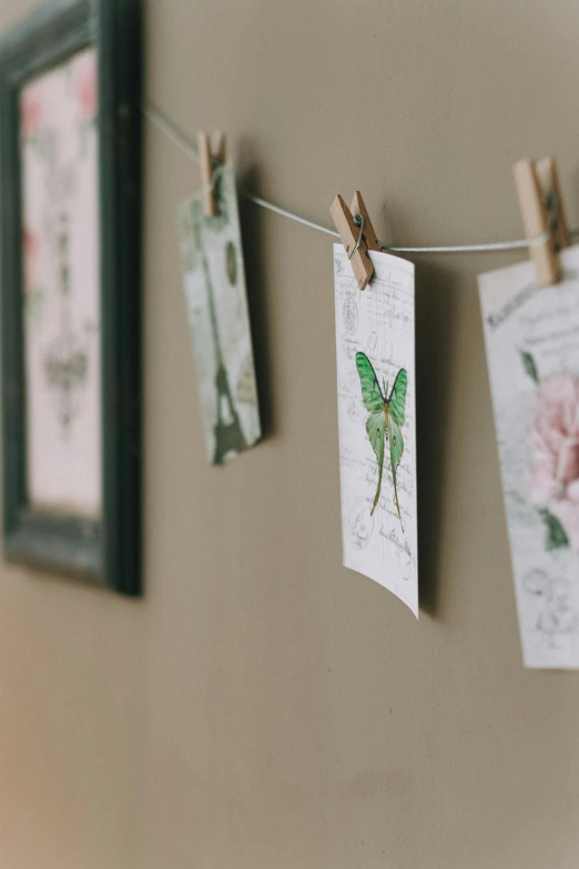 three pictures hanging on the clothes line and decorated with clothes pins