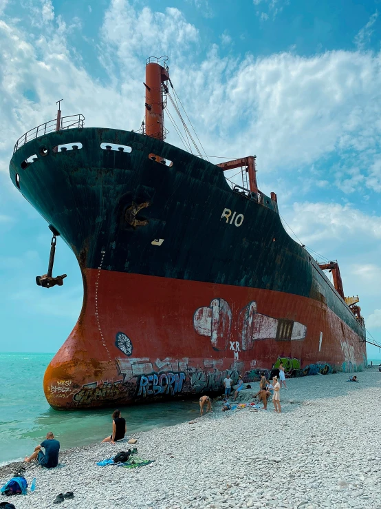 the large ship is sitting on top of a sandy beach