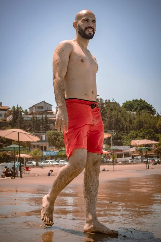 a man standing in the sand on a beach