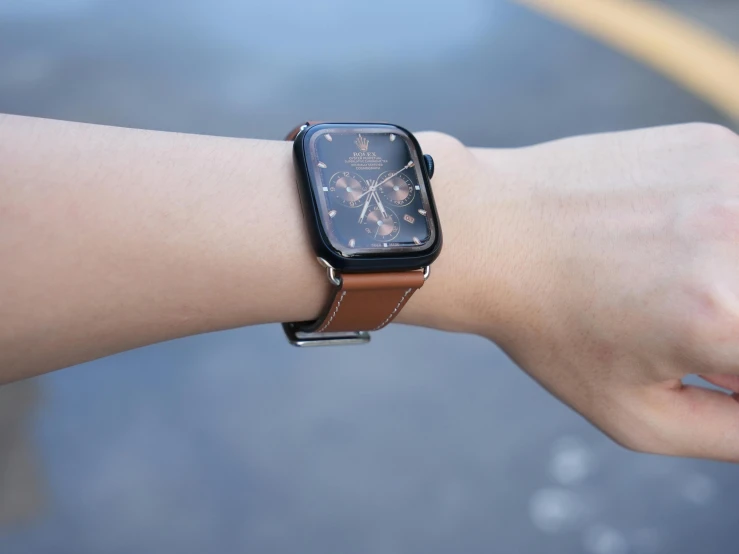 a woman is wearing a watch and is showing her wrist