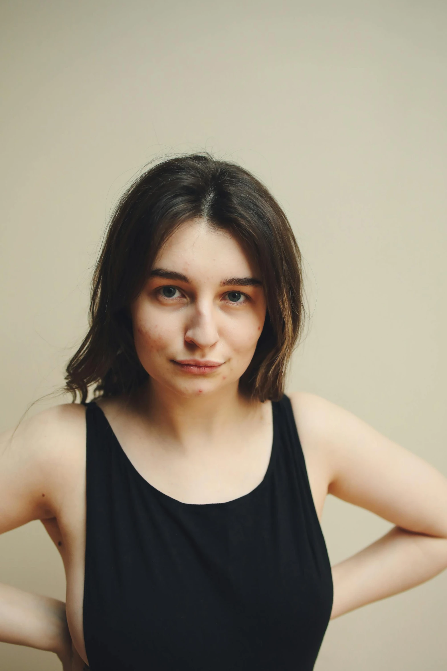 woman in black tank top looking off camera