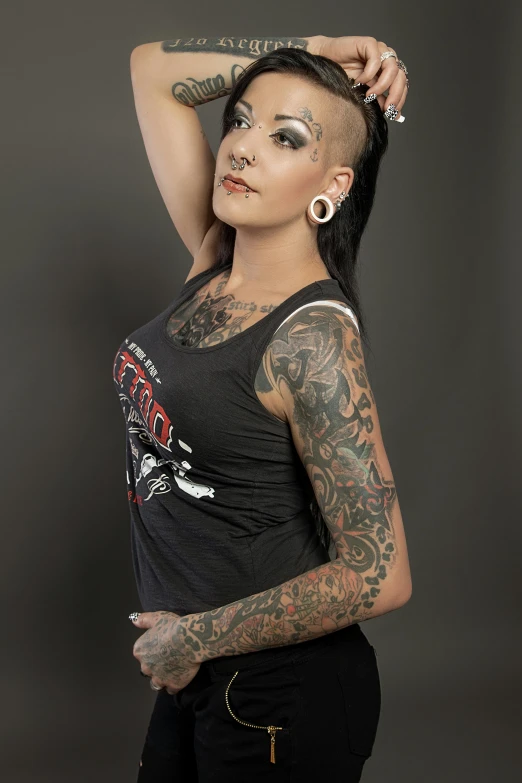 a woman with tattoos poses for the camera