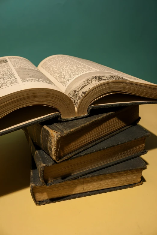 several old books stacked on top of each other