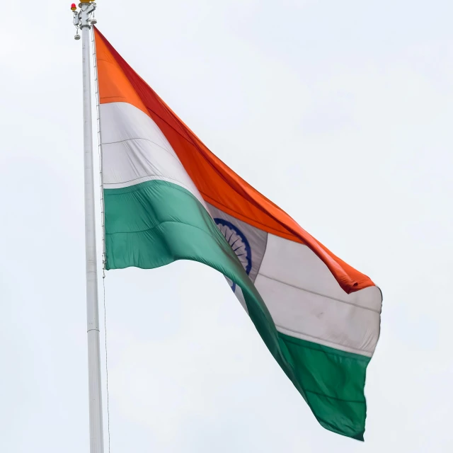 a large irish and indian flag flies in the sky