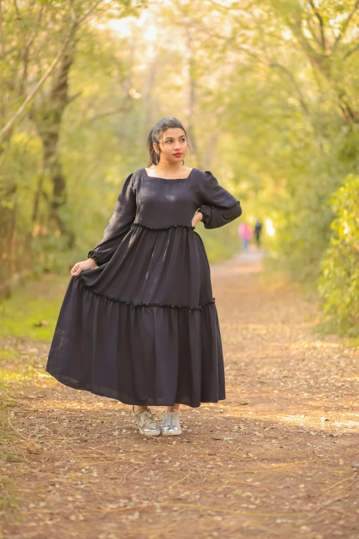 a beautiful woman posing for the camera in a dress and sandals