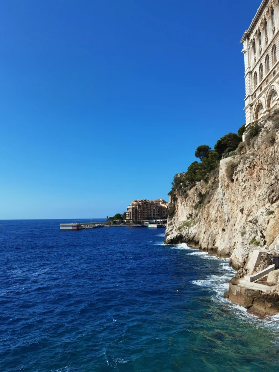 a beach sits near a rocky cliff