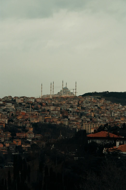 a building in the background and a hill behind it