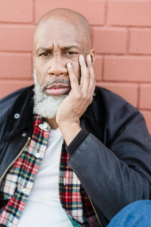 man with a white beard talking on a cell phone