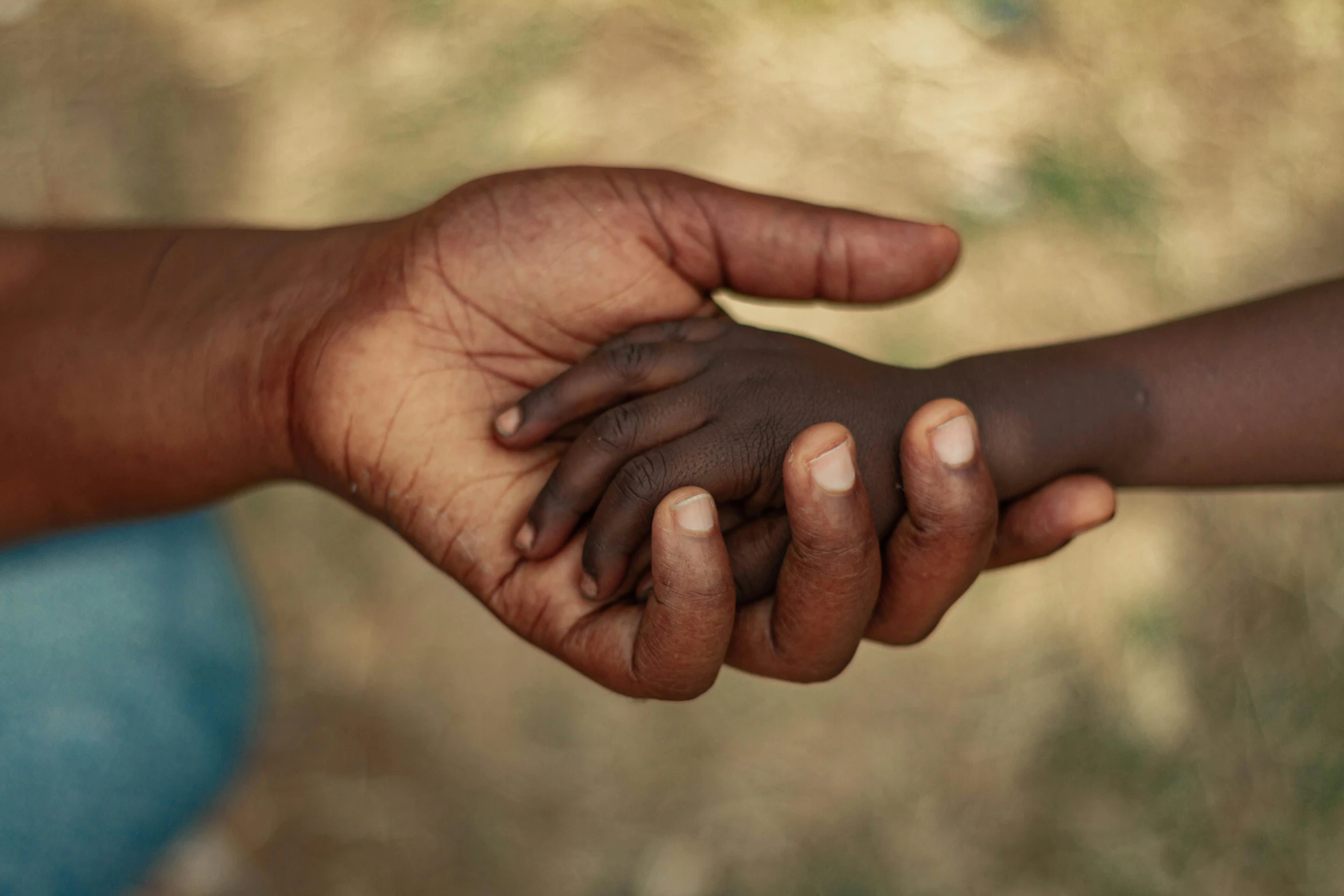 two people holding hands as one person holds the other