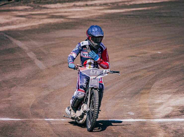 a man on a motor bike riding around in dirt