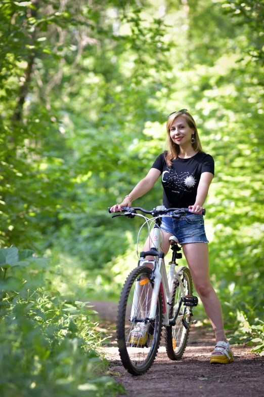 a beautiful blond lady posing with a mountain bike