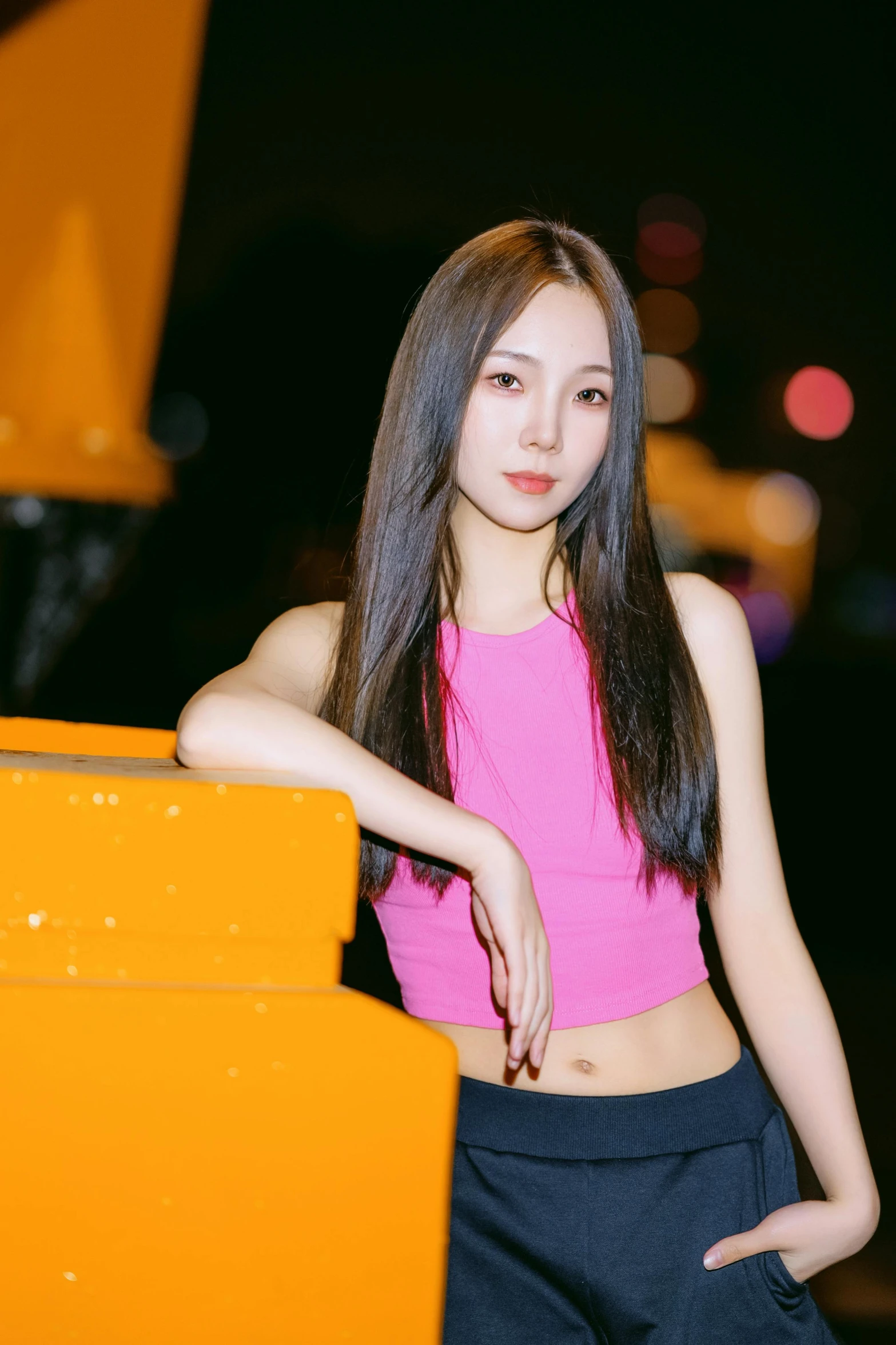 a woman standing next to a yellow and black truck