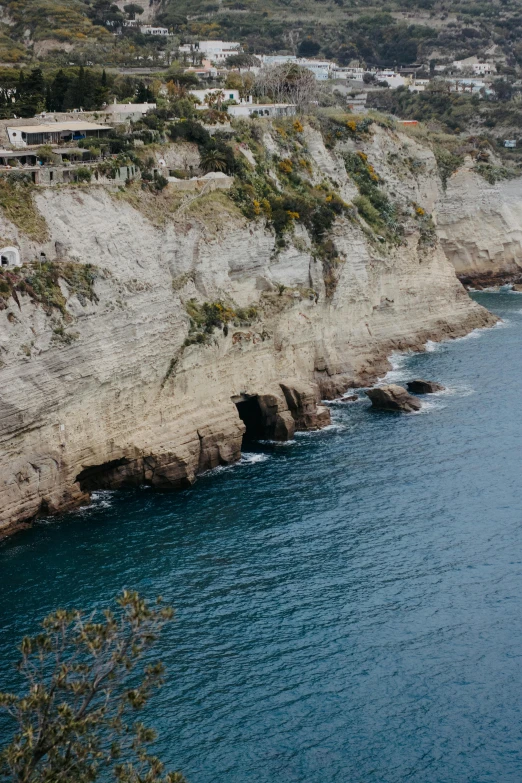 a rocky mountain on the coast with water