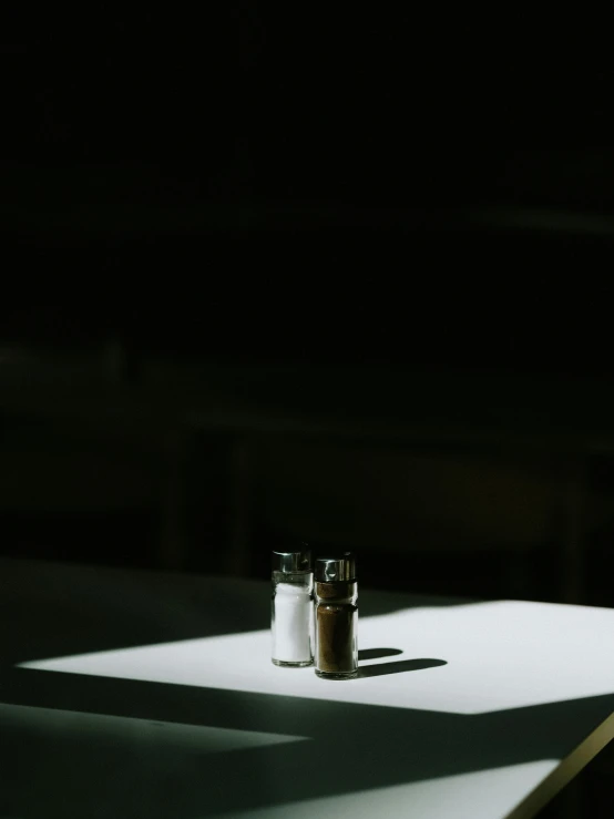 sun shining on a table with some jars