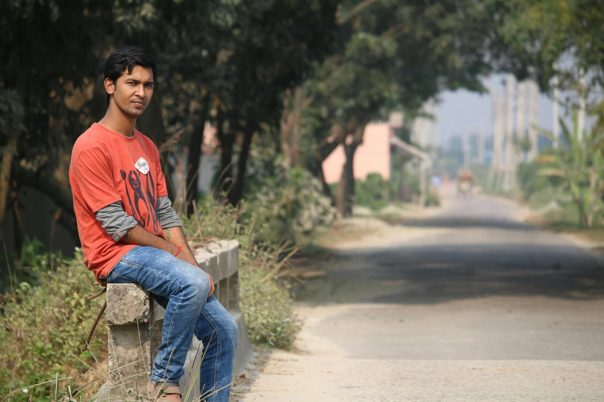 a man is sitting on a post in the street