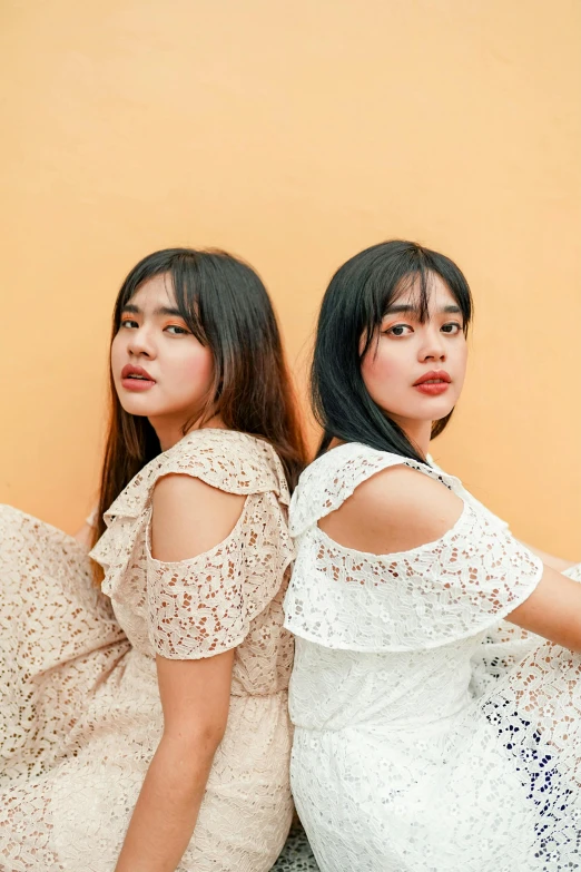 two girls in dresses are posing for a po