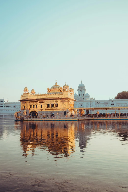 a large white palace sits on top of the water