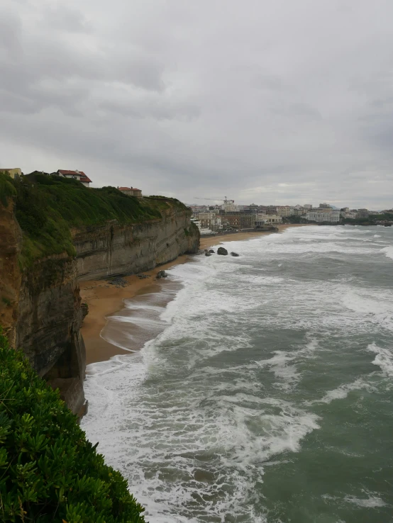 ocean view with houses on cliff by ocean