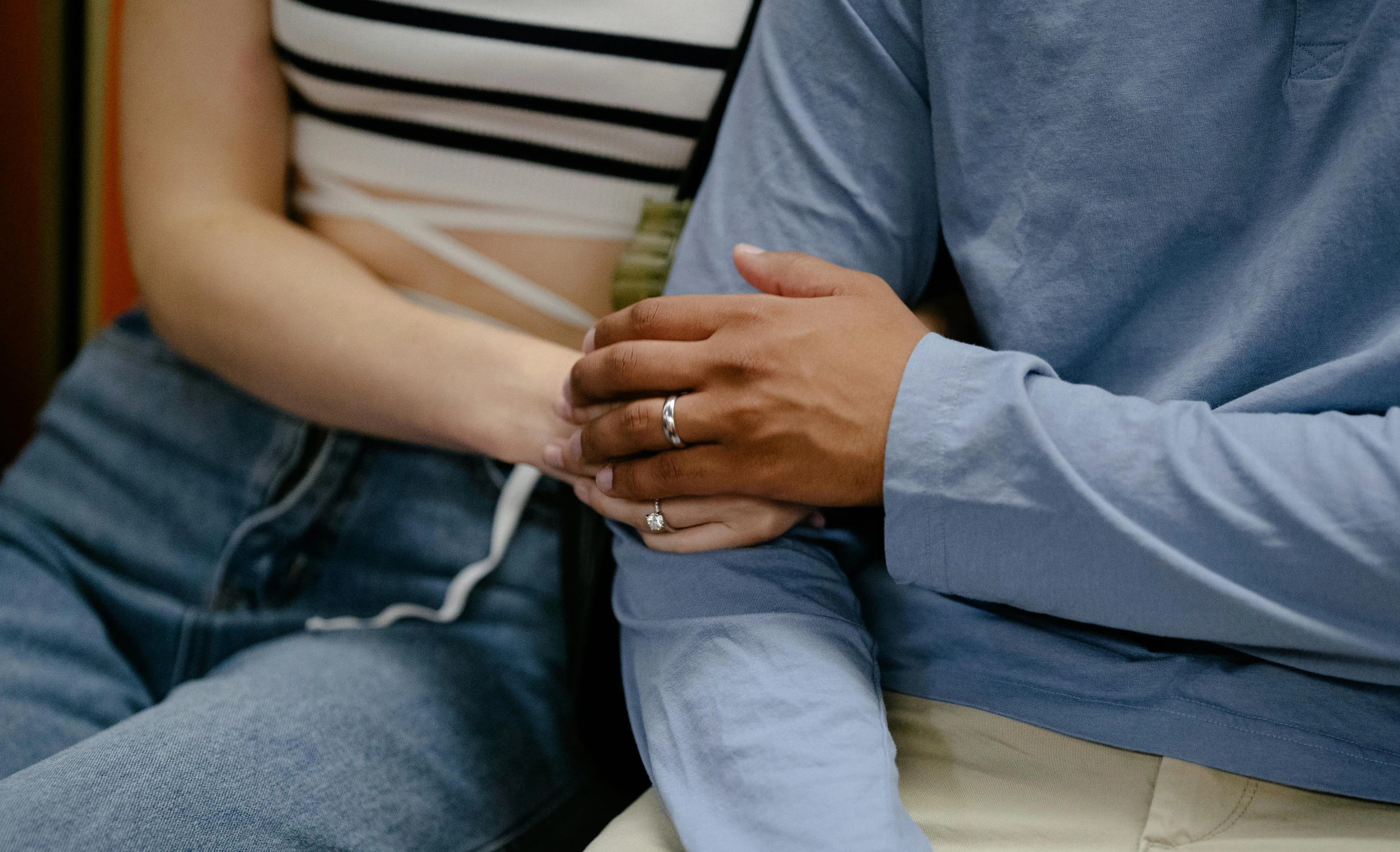 the man and woman are holding hands together