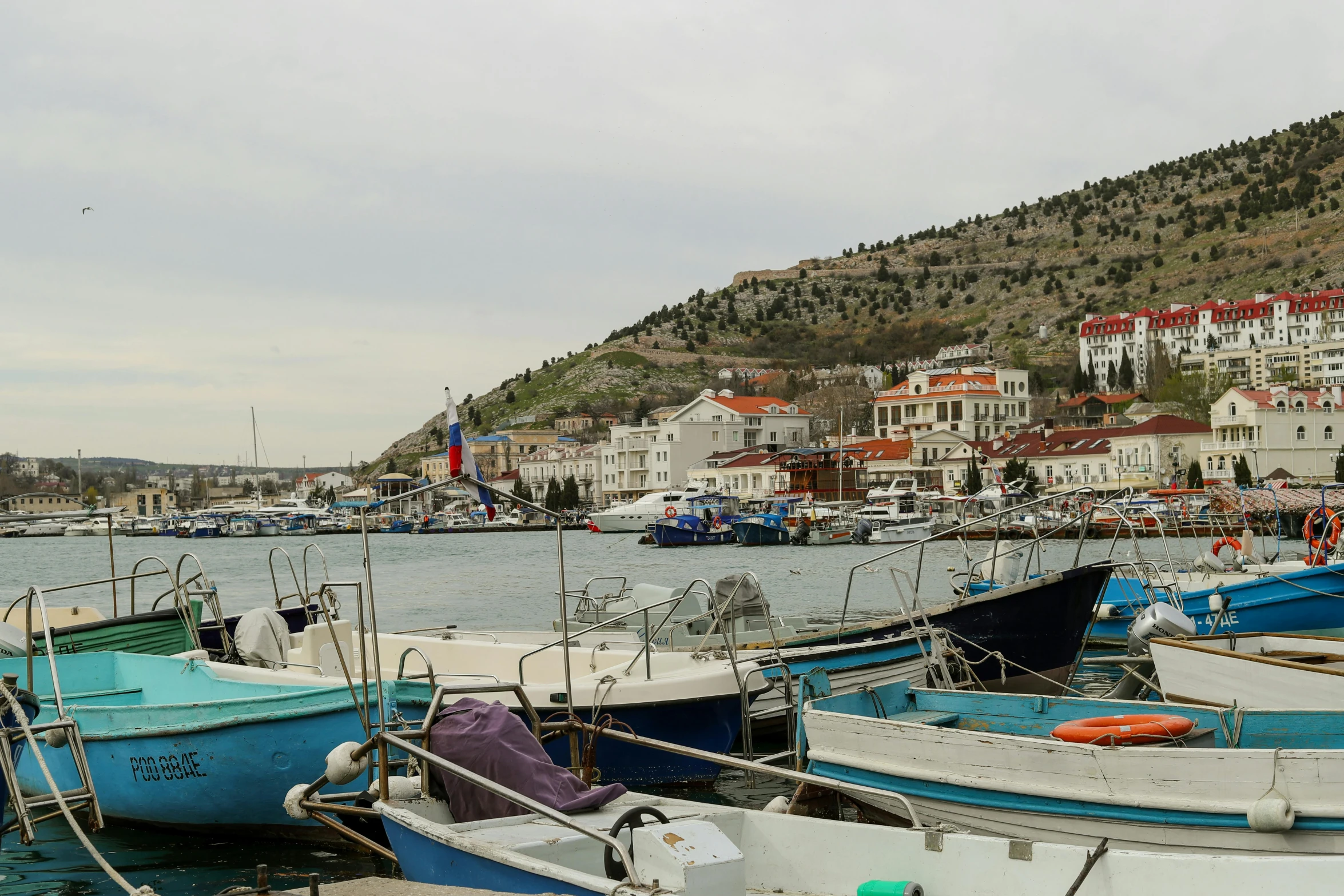 several boats docked at the pier on a lake