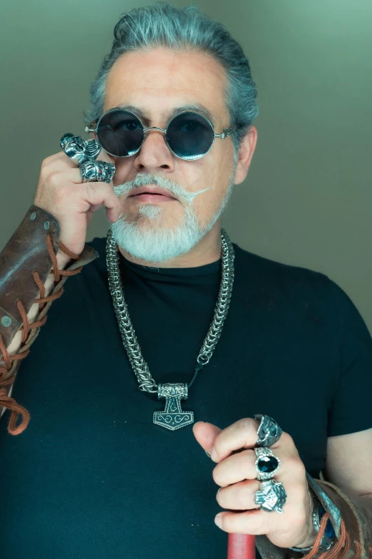 man holding baseball glove with silver colored details on both hands