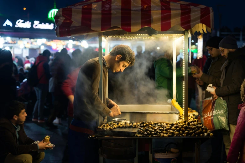 an older man preparing soing in a smoke machine