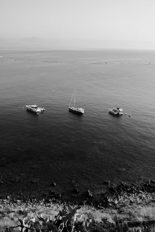 a group of boats sitting on top of a large body of water