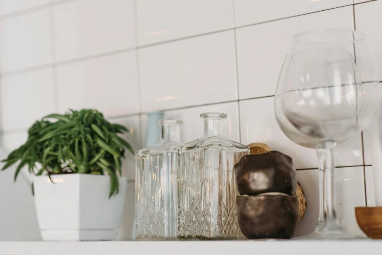 the shelves are full of glass bottles, pots, and other things