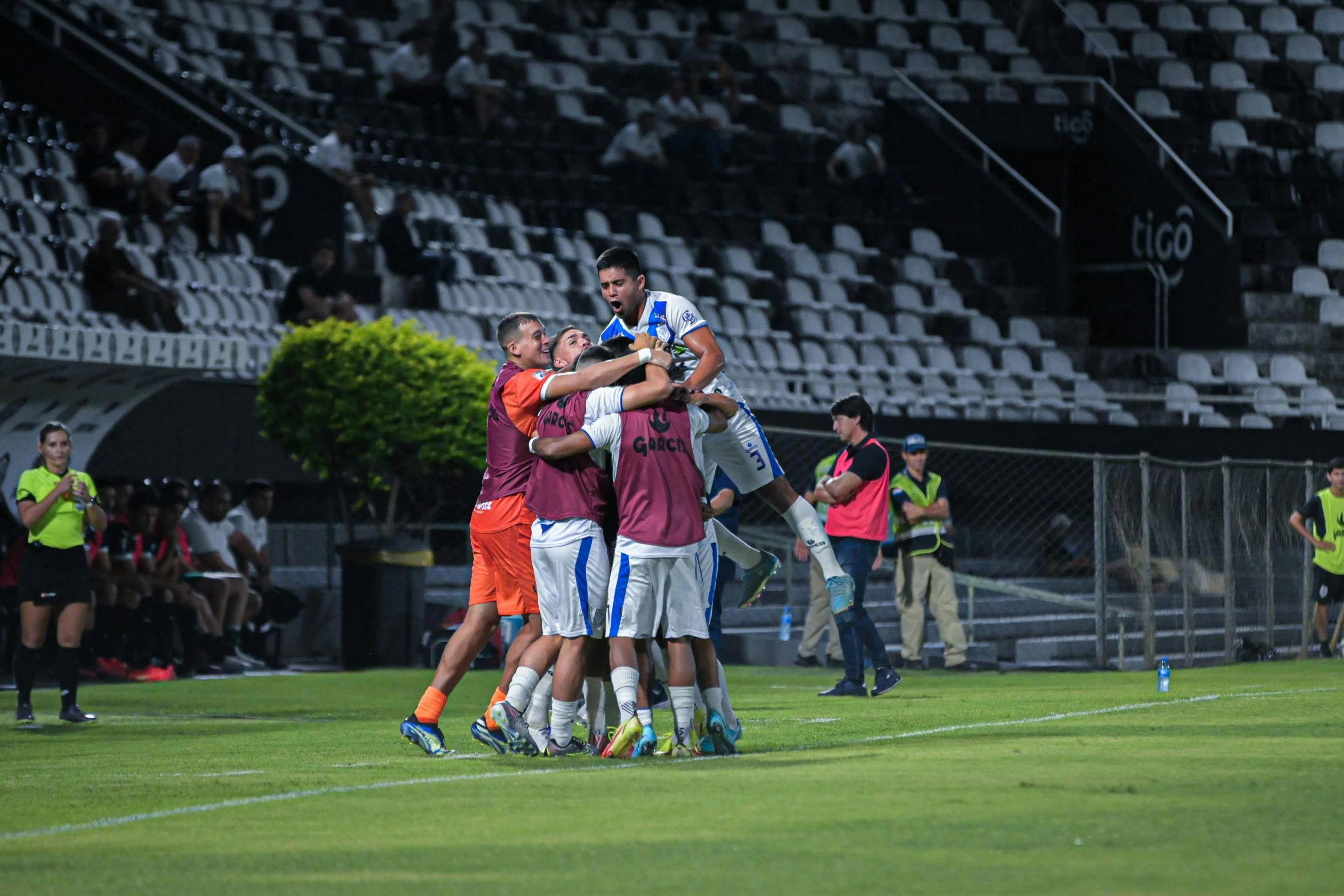 a group of men standing on top of a soccer field