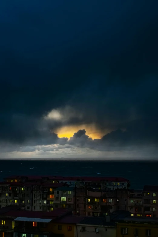 a cloudy sky that is over some buildings