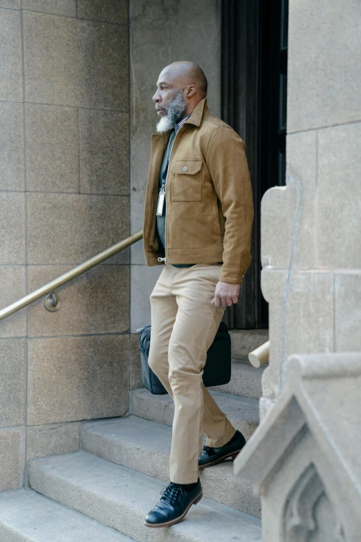 a man standing next to a door while walking up steps