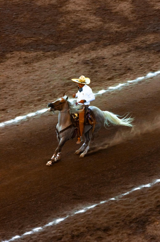 the jockey is riding his horse around the track