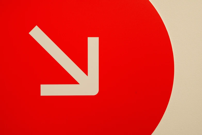 red and white circle with white arrows indicating a left turn