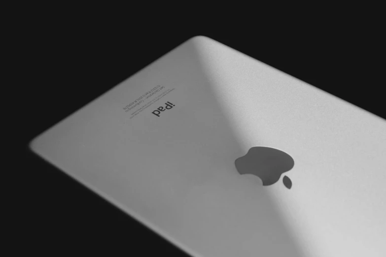 an apple tablet on a black background