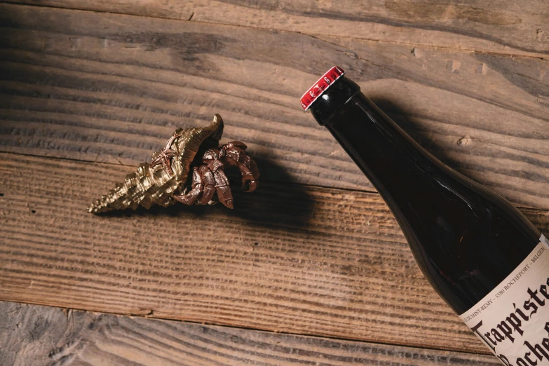 a bottle of beer on top of a wooden table