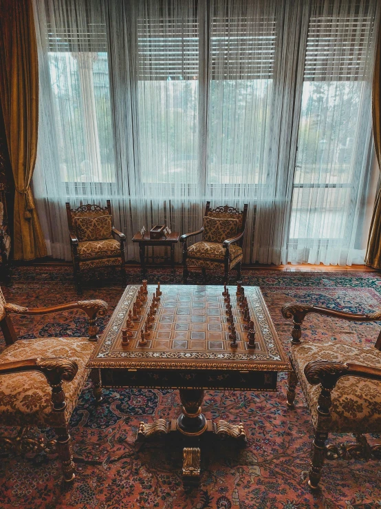 an ornately decorated living room with gold furniture