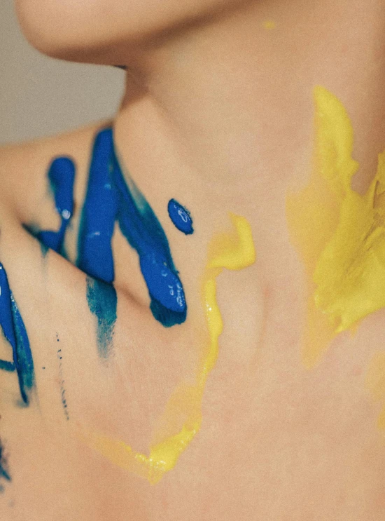 close up of paint smeared on a woman chest