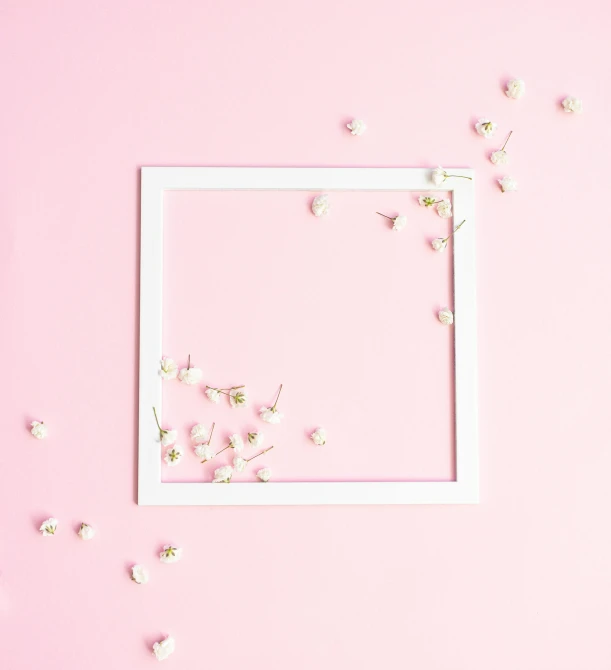 a framed po sitting on top of a pink surface