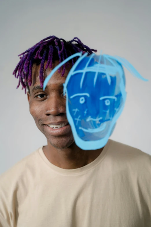 a man with dreadlocks and a blue mask