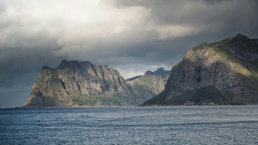 a mountain range sitting on top of a body of water