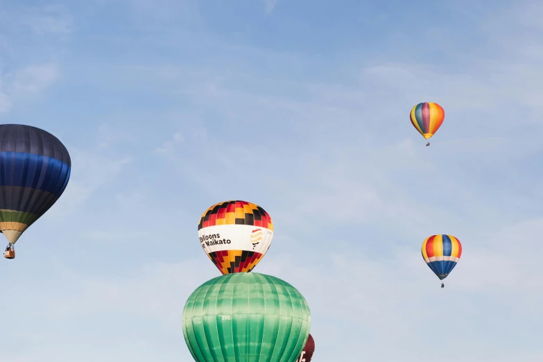 several colorful  air balloons being flown high