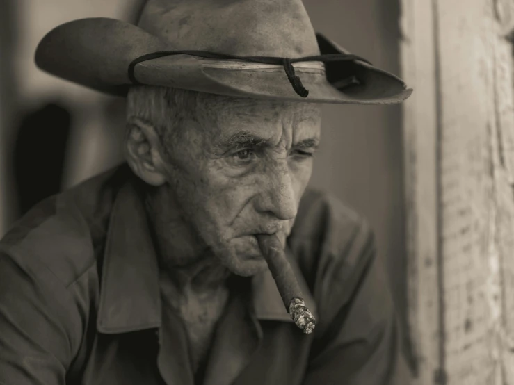 an old man with a cigar and hat