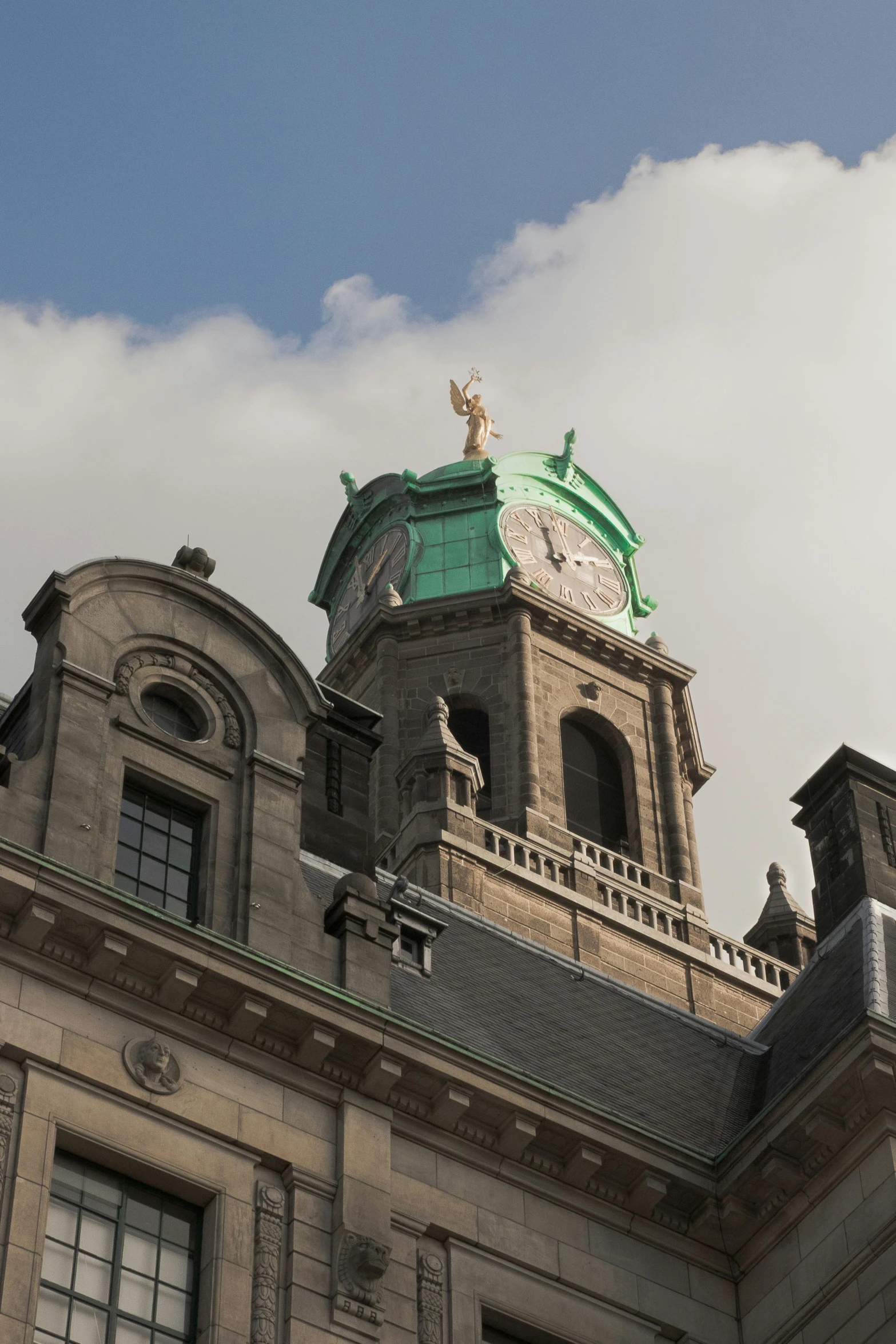 a clock tower with a green top on an old building