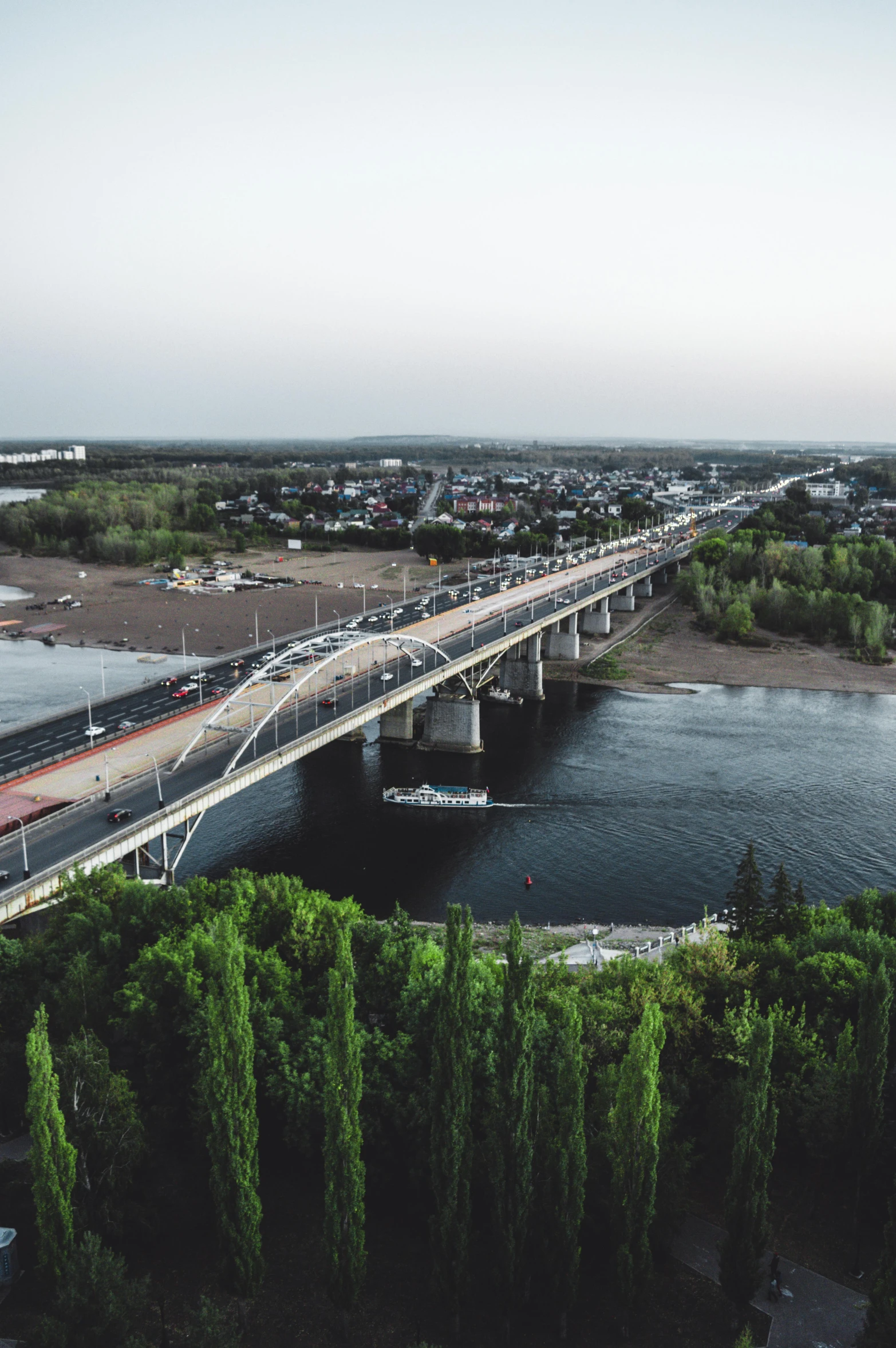 a train traveling over a bridge crossing a large river