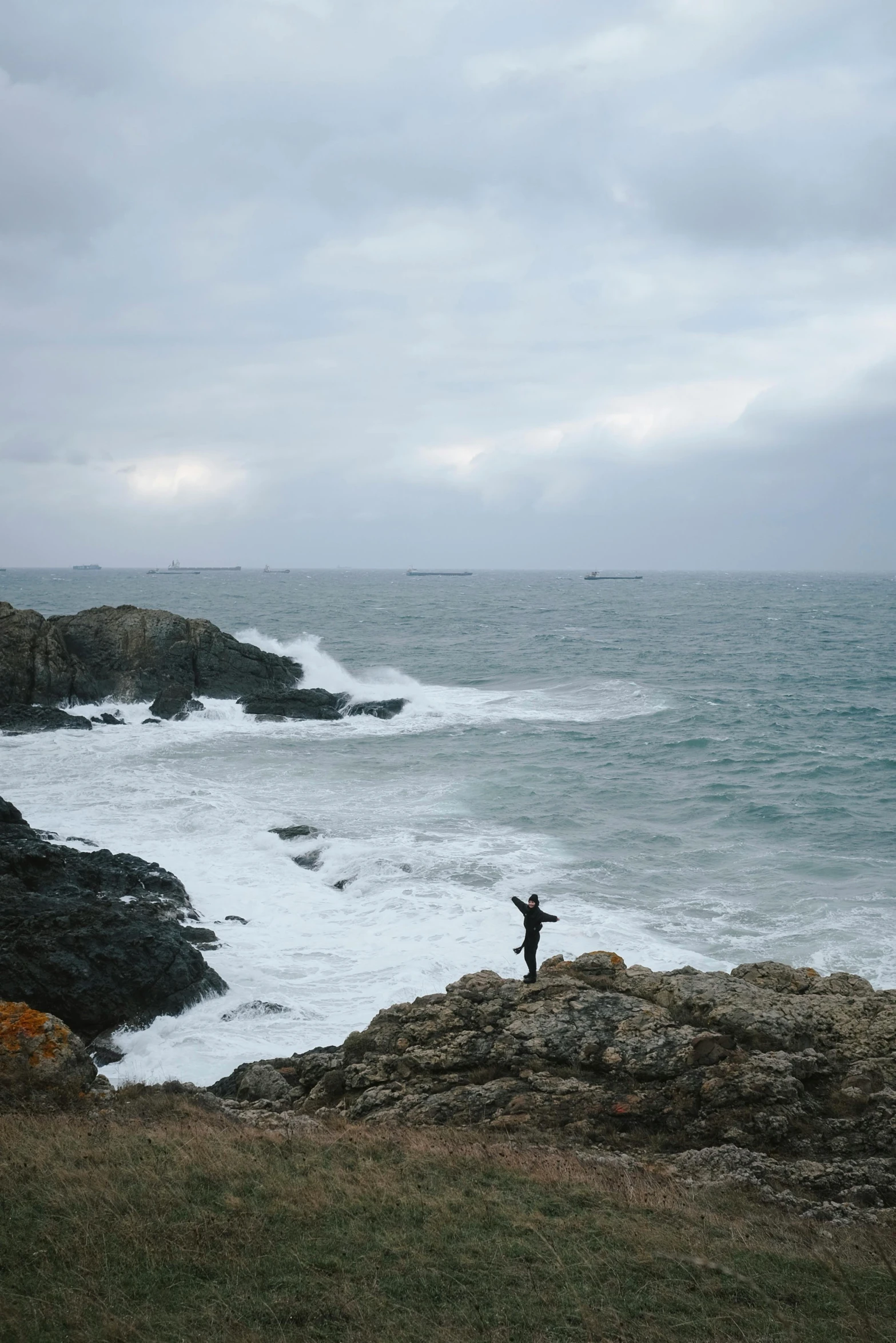 a person with arms outstretched on the shore