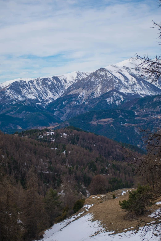 a view of the mountains from a snowy summit