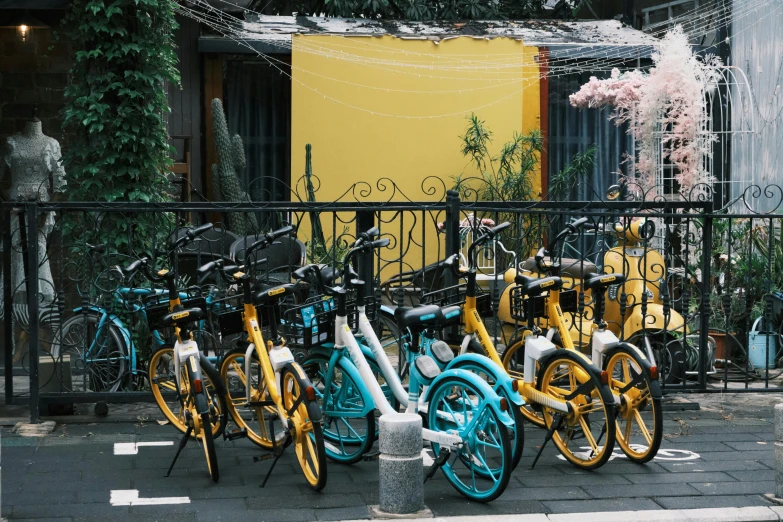 bicycles are parked in front of an iron fence