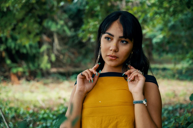 a beautiful young woman standing in a forest