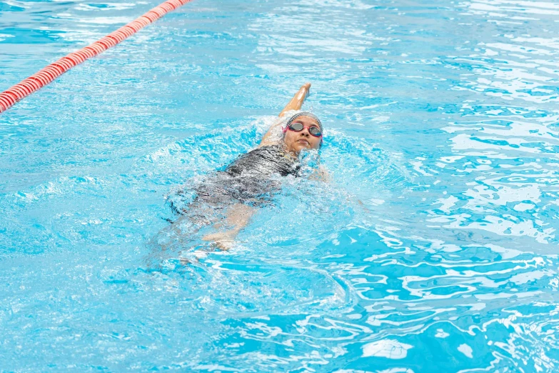 a swimming girl is in the blue water