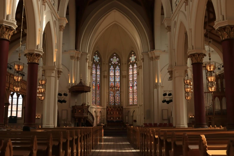 the interior of an old church with columns and lights